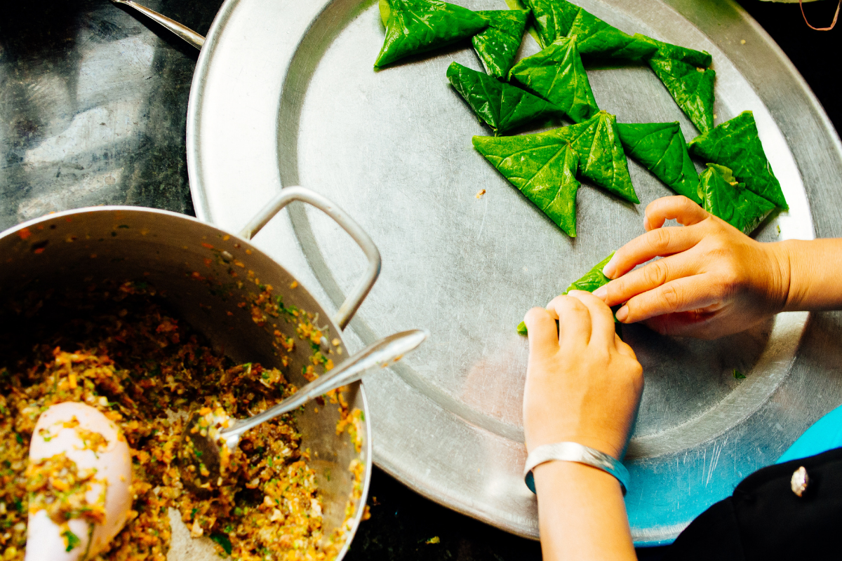Hands preparing food as part of vocational training for survivors.